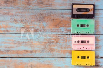 Bild på Top view above shot of retro tape cassette on wood table - vintage pastel color effect styles